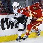 
              Los Angeles Kings' Sean Durzi, left, is checked by Calgary Flames' Milan Lucic during the first period of an NHL hockey game Thursday, March 31, 2022, in Calgary, Alberta. (Jeff McIntosh/The Canadian Press via AP)
            