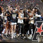 
              Central Florida's Diamond Battles (3) and teammates celebrate a win over South Florida in an NCAA college basketball game for the American Athletic Conference women's tournament championship Thursday, March 10, 2022, in Fort Worth, Texas. (AP Photo/Tony Gutierrez)
            