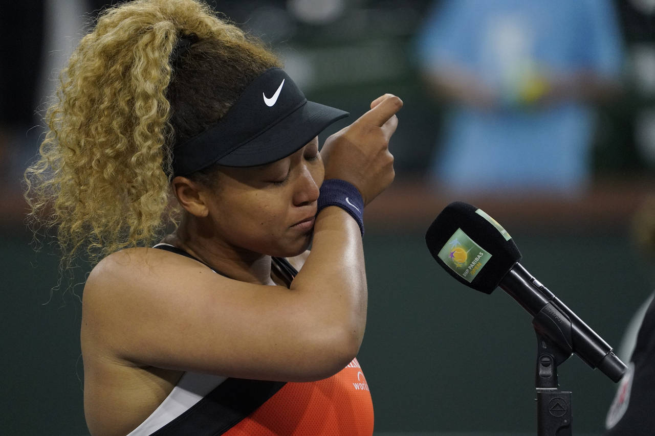 Naomi Osaka, of Japan, is emotional as she speaks to the crowd after losing her match to Veronika K...