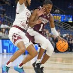 
              Iverson Molinar (1) tries to get around South Carolina guard James Reese V (0) during the first half of an NCAA men's college basketball game at the Southeastern Conference tournament in Tampa, Fla., Thursday, March 10, 2022. (AP Photo/Chris O'Meara)
            