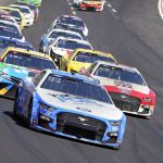 
              Pole-sitter Chase Briscoe (14) leads the pack into the first turn during a NASCAR Cup Series auto race at Atlanta Motor Speedway in Hampton, Ga., Sunday, March 20, 2022. (AP Photo/John Bazemore)
            