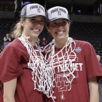 
              Stanford guards and twin sisters Lexie Hull, left, and Lacie Hull, right, wear nets after they were cut down after a college basketball game against Texas in the Elite 8 round of the NCAA tournament, Sunday, March 27, 2022, in Spokane, Wash. Stanford won 59-50. (AP Photo/Young Kwak)
            