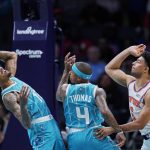 
              Charlotte Hornets guards Kelly Oubre Jr., left, and Isaiah Thomas, center, vie for a rebound with New York Knicks guard Quentin Grimes, right, during the first half of an NBA basketball game Wednesday, March 23, 2022, in Charlotte, N.C. (AP Photo/Rusty Jones)
            