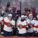 
              Florida Panthers' Ben Chiarot, left, acknowledges applauds from the crowd in his first game back after being traded from the Montreal Canadiens during first-period NHL hockey game action against the Canadiens in Montreal, Thursday, March 24, 2022. (Paul Chiasson/The Canadian Press via AP)
            