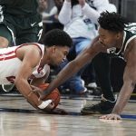 
              Wisconsin's Chucky Hepburn (23) and Michigan State's Marcus Bingham Jr. (30) dive for the ball during the second half of an NCAA college basketball game at the Big Ten Conference men's tournament Friday, March 11, 2022, in Indianapolis. (AP Photo/Darron Cummings)
            