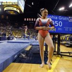 
              Auburn gymnast Sunisa Lee waits to perform at the University of Michigan, Saturday, March 12, 2022, in Ann Arbor, Mich. A record crowd came out to watch Lee, the reigning Olympic champion, and Auburn take on defending national champion Michigan. The arrival of Lee and several of her Olympic teammates at the collegiate level is helping fuel a spike in interest and participation in NCAA women's gymnastics. (AP Photo/Carlos Osorio)
            