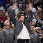 
              Dallas Mavericks guard Luka Doncic gestures as he watches his team play in the final seconds of an NBA basketball game against the Sacramento Kings in Dallas, Saturday, March, 5, 2022. The Mavericks won 114-113. (AP Photo/Tony Gutierrez)
            