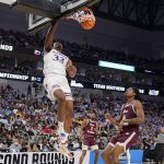
              Kansas forward David McCormack (33) dunks as Texas Southern guard AJ Lawson (2) and forward Brison Gresham (44) look on in the first half of a first-round game in the NCAA college basketball tournament in Fort Worth, Texas, Thursday, March 17, 2022. (AP Photo/Tony Gutierrez)
            