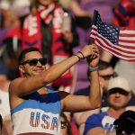 
              A spectator waves a United States flag prior to a FIFA World Cup qualifying soccer match between Panama and the United States, Sunday, March 27, 2022, in Orlando, Fla. (AP Photo/Julio Cortez)
            