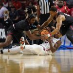 
              Auburn guard K.D. Johnson, middle, battles for a loose ball between Jacksonville State forward Kayne Henry and guard Darian Adams, right, during the first half of a college basketball game in the first round of the NCAA tournament on Friday, March 18, 2022, in Greenville, S.C. (AP Photo/Chris Carlson)
            