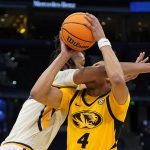 
              LSU center Efton Reid, left, fouls Missouri guard Javon Pickett (4) as he goes up for a shot during the second half of an NCAA men's college basketball game at the Southeastern Conference tournament in Tampa, Fla., Thursday, March 10, 2022. (AP Photo/Chris O'Meara)
            