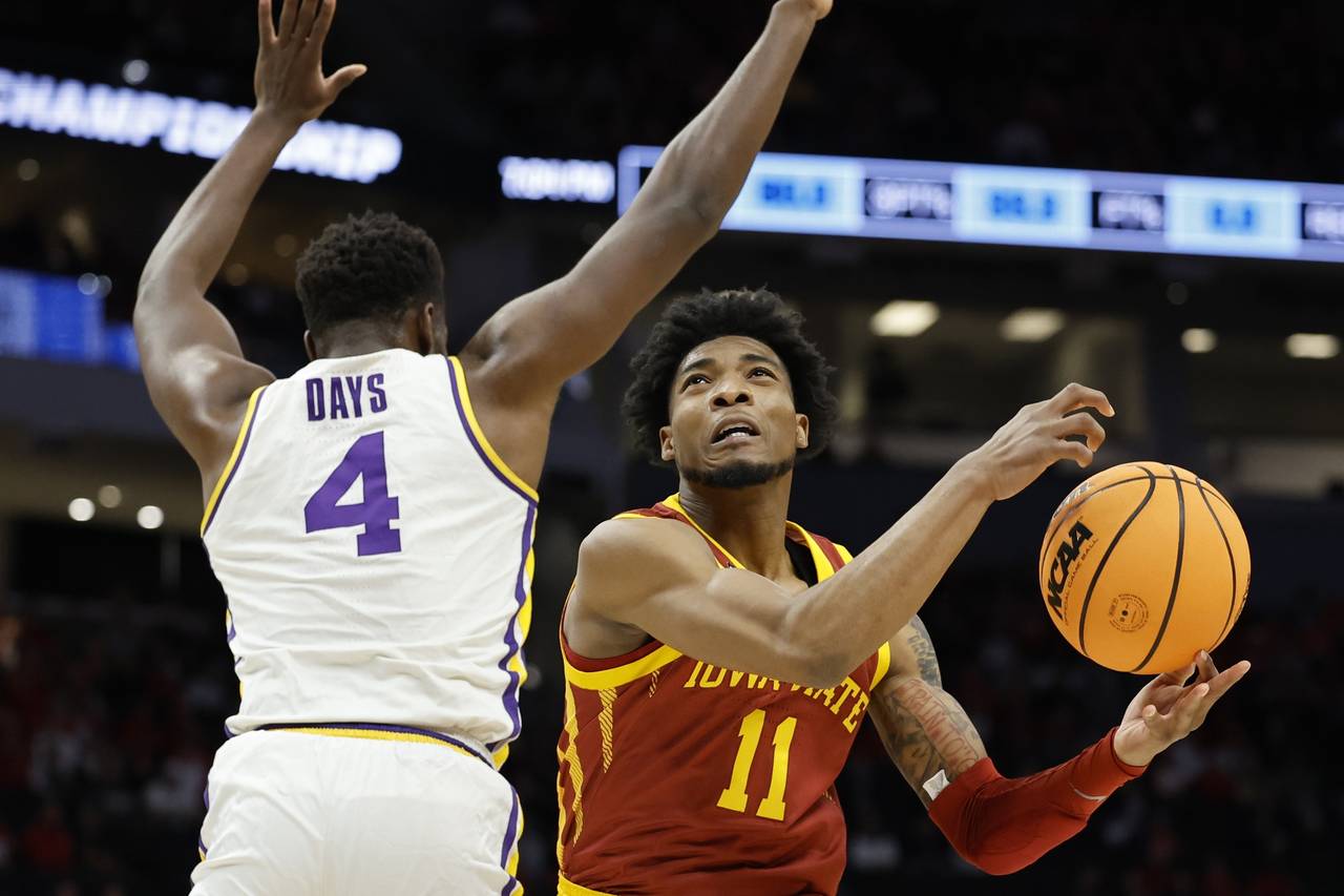 Iowa State's Tyrese Hunter shoots past LSU's Darius Days during the first half of a first round NCA...