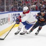 
              Montreal Canadiens' Ben Chiarot (8) and Edmonton Oilers' Derek Ryan (10) battle for the puck during second-period NHL hockey game action in Edmonton, Alberta, Saturday, March 5, 2022. (Jason Franson/The Canadian Press via AP)
            