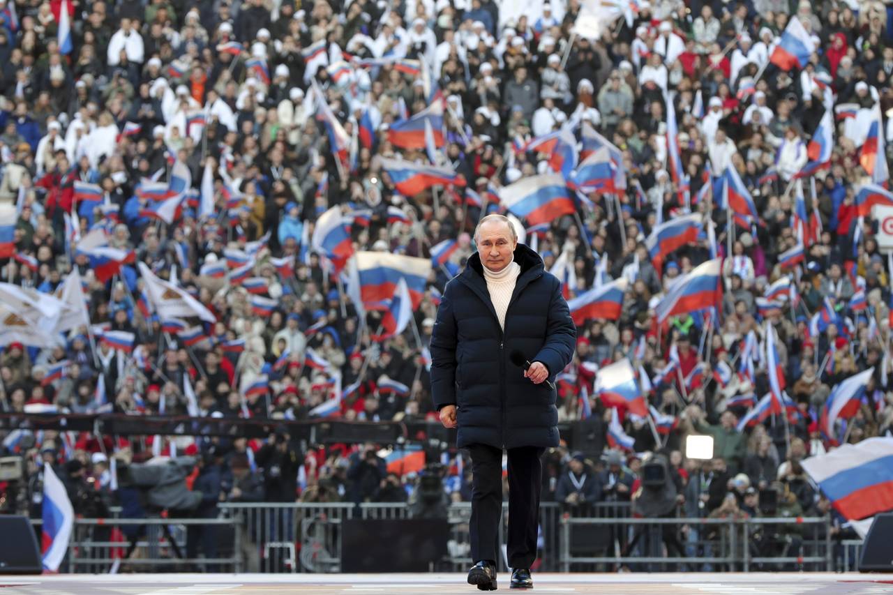 Russian President Vladimir Putin arrives to deliver his speech at the concert marking the eighth an...