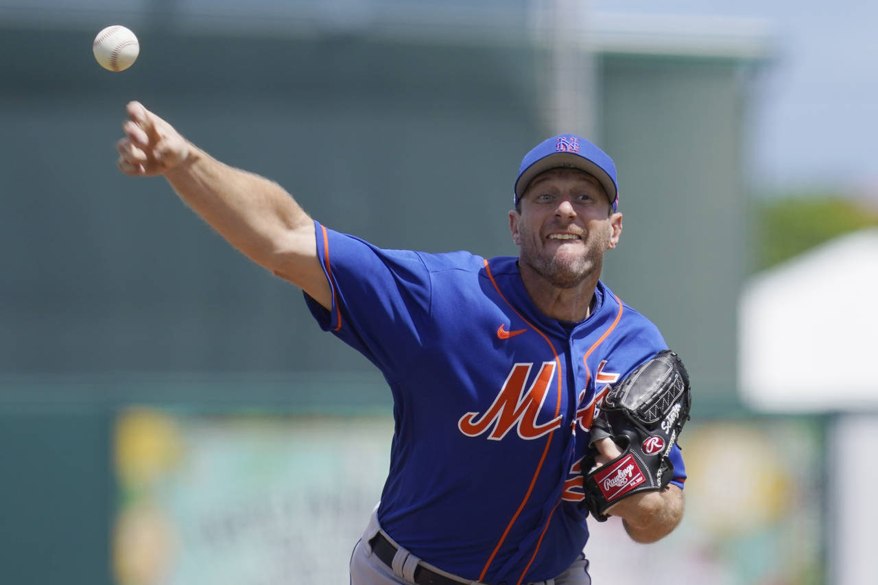 New York Mets' Max Scherzer pitches in the second inning of a spring training baseball game against...