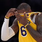 
              Los Angeles Lakers forward LeBron James wipes his face with his jersey during the first half of an NBA basketball game against the Dallas Mavericks Tuesday, March 1, 2022, in Los Angeles. (AP Photo/Mark J. Terrill)
            