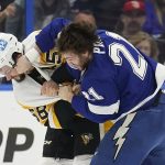 
              Tampa Bay Lightning center Brayden Point (21) and Pittsburgh Penguins defenseman Kris Letang (58) fight during the first period of an NHL hockey game Thursday, March 3, 2022, in Tampa, Fla. (AP Photo/Chris O'Meara)
            