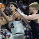 
              Gonzaga's Anton Watson (22) shoots around Saint Mary's Matthias Tass (11) during the first half of an NCAA college basketball championship game at the West Coast Conference tournament Tuesday, March 8, 2022, in Las Vegas. (AP Photo/John Locher)
            