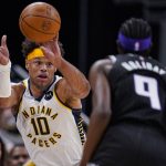 
              Indiana Pacers forward Justin Anderson (10) throws a pass over Sacramento Kings forward Justin Holiday (9) on a fast break during the second half of an NBA basketball game in Indianapolis, Wednesday, March 23, 2022. The Kings defeated the Pacers 110-109. (AP Photo/Michael Conroy)
            