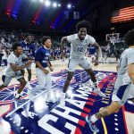 
              Players from St. Peter's celebrate after defeating Monmouth in an NCAA college basketball game during the championship of the Metro Atlantic Athletic Conference tournament, Saturday, March 12, 2022, in Atlantic City, N.J. St. Peter's won 60-54. (AP Photo/Matt Rourke)
            
