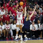 
              NC State forward Jakia Brown-Turner (11) puts up a three point shot against nConnecticut guard Paige Bueckers (5) to tie the game at the end of overtime in the East Regional final college basketball game of the NCAA women's tournament, Monday, March 28, 2022, in Bridgeport, Conn. (AP Photo/Frank Franklin II)
            
