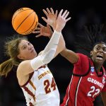 
              Iowa State guard Ashley Joens (24) catches a pass over Georgia forward Malury Bates (22) during the first half of a second-round game in the NCAA women's college basketball tournament, Sunday, March 20, 2022, in Ames, Iowa. (AP Photo/Charlie Neibergall)
            