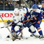 
              New York Islanders' Noah Dobson (8) and goaltender Ilya Sorokin protect the net from Tampa Bay Lightning's Corey Perry (10) during the first period of an NHL hockey game Sunday, March 27, 2022, in Elmont, N.Y. (AP Photo/Frank Franklin II)
            