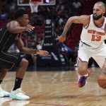 
              New York Knicks guard Evan Fournier (13) drives past Miami Heat guard Kyle Lowry during the first half of an NBA basketball game Friday, March 25, 2022, in Miami. (AP Photo/Jim Rassol)
            
