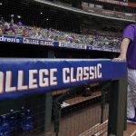 
              LSU baseball coach Jay Johnson stands at the dugout before an NCAA college baseball game against Oklahoma at Minute Maid Park, home of the Houston Astros, during the Shriners Children's College Classic, Friday, March 4, 2022, in Houston. College baseball might turn out to be an attractive alternative for baseball fans if the Major League Baseball lockout extends deep into the spring. (AP Photo/David J. Phillip)
            