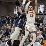 
              Princeton guard Jaelin Llewellyn (13) shoots against Yale's Bez Mbeng during the first half of an NCAA Ivy League men's college basketball championship game, Sunday, March 13, 2022, in Cambridge, Mass. (AP Photo/Mary Schwalm)
            
