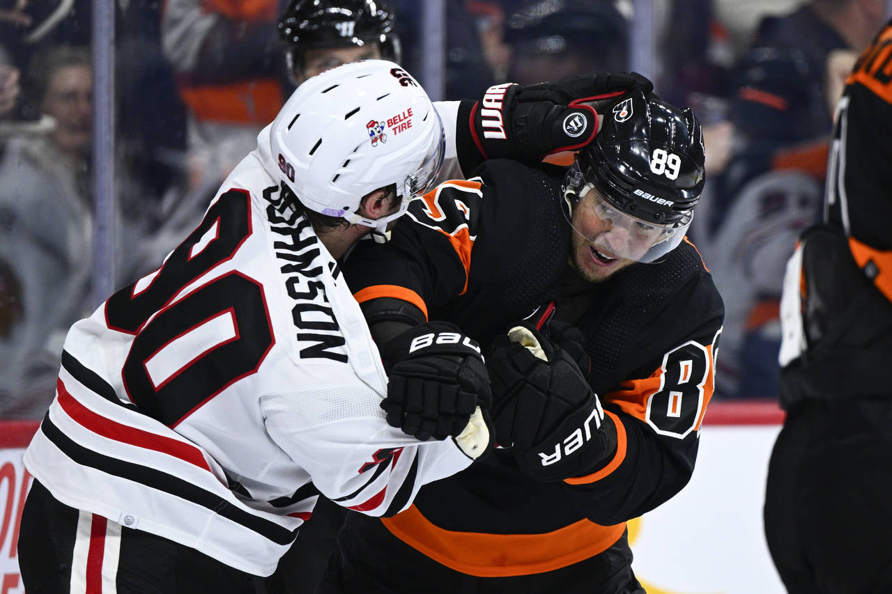 Philadelphia Flyers' Cam Atkinson, right, scuffles with Chicago Blackhawks' Tyler Johnson after Atk...