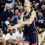 
              Connecticut guard Paige Bueckers (5) reacts in double overtime against NC State during the East Regional final college basketball game of the NCAA women's tournament, Monday, March 28, 2022, in Bridgeport, Conn. (AP Photo/Frank Franklin II)
            