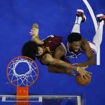 
              Philadelphia 76ers' Joel Embiid, right, tries to get a shot past Cleveland Cavaliers' Jarrett Allen during the first half of an NBA basketball game, Friday, March 4, 2022, in Philadelphia. (AP Photo/Matt Slocum)
            