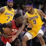 
              Los Angeles Lakers' Kent Bazemore (9) reaches to steal the ball from Houston Rockets' Dennis Schroder (17) during the first half of an NBA basketball game Wednesday, March 9, 2022, in Houston. (AP Photo/David J. Phillip)
            