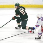 
              Minnesota Wild left wing Kirill Kaprizov (97) controls the puck in front of New York Rangers center Jonny Brodzinski (76) in the first period of an NHL hockey game Tuesday, March 8, 2022, in St. Paul, Minn. (AP Photo/Andy Clayton-King)
            