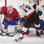 
              Ottawa Senators' Zach Sanford (13) moves in on Montreal Canadiens goaltender Jake Allen as Canadiens' Nick Suzuki defends during the first period of an NHL hockey game Saturday, March 19, 2022, in Montreal. (Graham Hughes/The Canadian Press via AP)
            