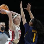 
              Utah's Dru Gylten (10) passes around California's Leilani McIntosh (1) during the first half of an NCAA college basketball game in the first round of the Pac-12 women's tournament Wednesday, March 2, 2022, in Las Vegas. (AP Photo/John Locher)
            
