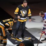 
              Pittsburgh Penguins' Sidney Crosby (87) and New York Rangers' Barclay Goodrow (21) prepare to take a ceremonial puck drop from recently retired Pittsburgh Steelers quarterback Ben Roethlisberger before an NHL hockey game in Pittsburgh, Tuesday, March 29, 2022. (AP Photo/Gene J. Puskar)
            