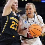 
              Michigan guard Danielle Rauch (23) defends Louisville guard Hailey Van Lith (10) during the first half of a college basketball game in the Elite 8 round of the NCAA women's tournament Monday, March 28, 2022, in Wichita, Kan. (AP Photo/Jeff Roberson)
            