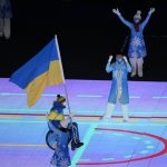 
              Maksym Yarovyi of Ukraine carries the flag as the team makes their entrance during the opening ceremony at the 2022 Winter Paralympics, Friday, March 4, 2022, in Beijing. (AP Photo/Dita Alangkara)
            
