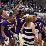 
              Albany's Taniya Hanner (22), Abby Robinson (32) and Lucia Decortes (13) celebrate with head coach Colleen Mullen after winning the America East Conference championship tournament in an NCAA college basketball game against Maine, Friday, March 11, 2022, at Orono, Maine. (AP Photo/Robert F. Bukaty)
            