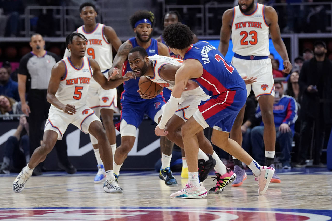 New York Knicks guard Alec Burks steals the ball from Detroit Pistons guard Cade Cunningham (2) dur...