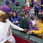 
              LSU's Tre' Morgan signs autographs for fans before an NCAA college baseball game against Oklahoma at Minute Maid Park, home of the Houston Astros, during the Shriners Children's College Classic, Friday, March 4, 2022, in Houston. College baseball might turn out to be an attractive alternative for baseball fans if the Major League Baseball lockout extends deep into the spring. (AP Photo/David J. Phillip)
            