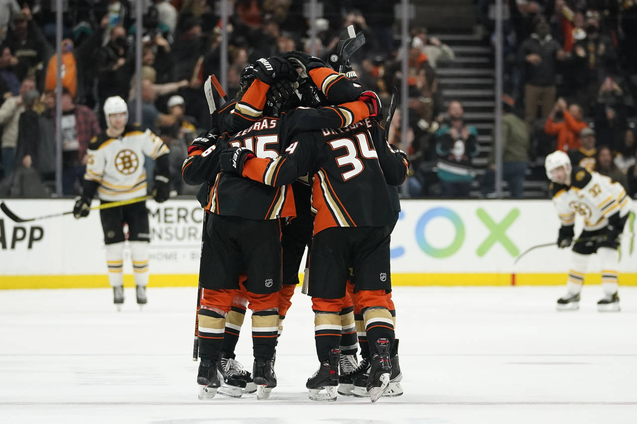 Anaheim Ducks center Trevor Zegras (46) celebrates with teammates after scoring a goal during the t...