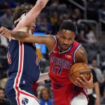 
              Detroit Pistons guard Rodney McGruder (17) pushes through Washington Wizards forward Corey Kispert during the first half of an NBA basketball game, Friday, March 25, 2022, in Detroit. (AP Photo/Carlos Osorio)
            