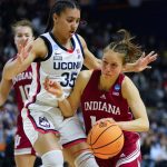 
              Indiana guard Ali Patberg (14) drives against Connecticut guard Azzi Fudd (35) during the third quarter of a college basketball game in the Sweet Sixteen round of the NCAA women's tournament, Saturday, March 26, 2022, in Bridgeport, Conn. (AP Photo/Frank Franklin II)
            
