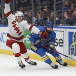 
              St. Louis Blues' Nick Leddy (4) fights for the puck against Carolina Hurricanes' Jesperi Kotkaniemi (82) during the first period of an NHL hockey game against Carolina Hurricanes the on Saturday, March 26, 2022 in St. Louis. (AP Photo/Michael Thomas)
            