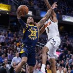 
              Indiana Pacers guard Keifer Sykes (28) is fouled by Denver Nuggets guard Bones Hyland (3) as he shoots during the second half of an NBA basketball game in Indianapolis, Wednesday, March 30, 2022. The Nuggets won 125-118. (AP Photo/Michael Conroy)
            