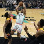 
              San Antonio Spurs forward Keldon Johnson (3) shoots over Utah Jazz guard Trent Forrest, left, during the first half of an NBA basketball game, Friday, March 11, 2022, in San Antonio. (AP Photo/Eric Gay)
            