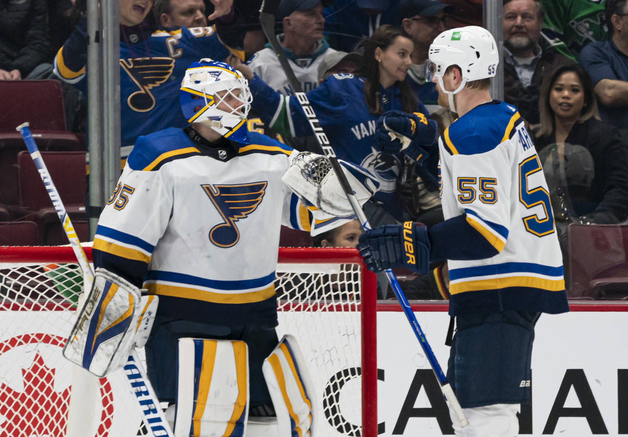 St. Louis Blues' goalie Ville Husso (35) is celebrates with Colton Parayko after the Blues defeated...